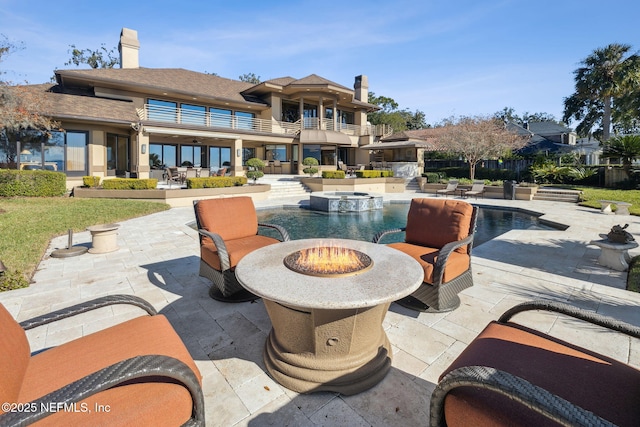 view of patio with a fenced in pool and an outdoor fire pit