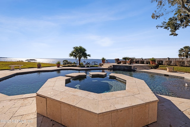 view of pool featuring a water view and an in ground hot tub