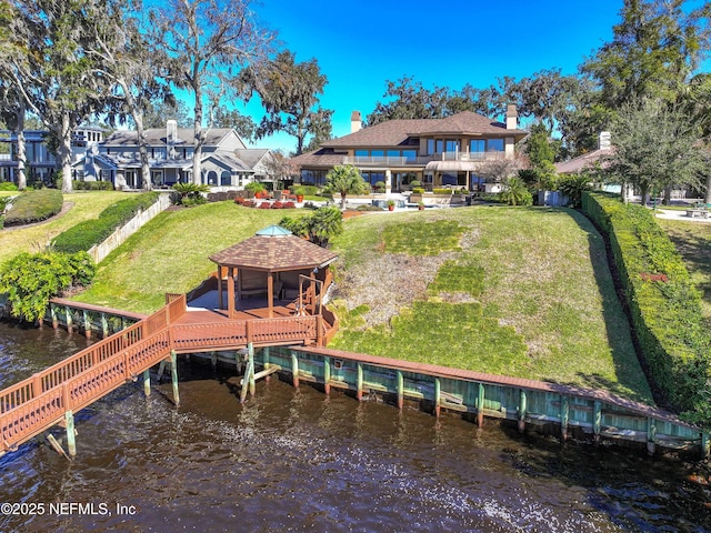 view of dock featuring a water view, a gazebo, and a lawn