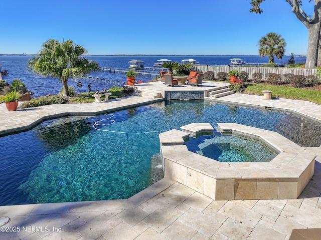 view of pool featuring an in ground hot tub, a patio area, pool water feature, and a water view