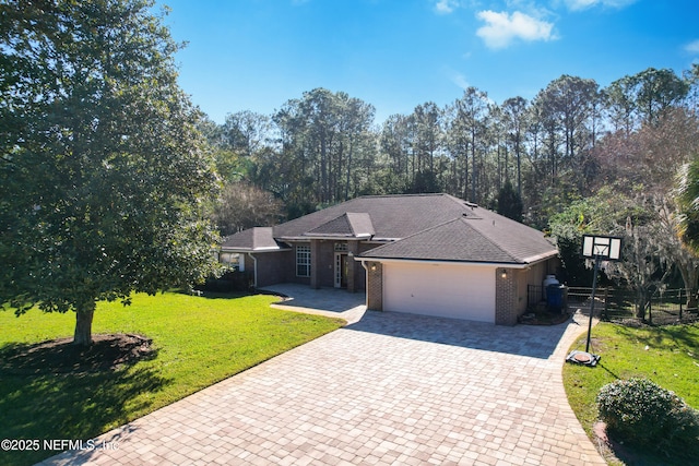 ranch-style house with a garage and a front lawn