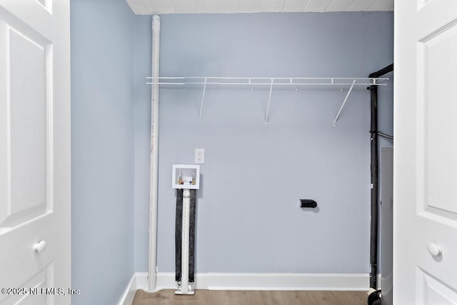 washroom with hookup for a washing machine and hardwood / wood-style floors