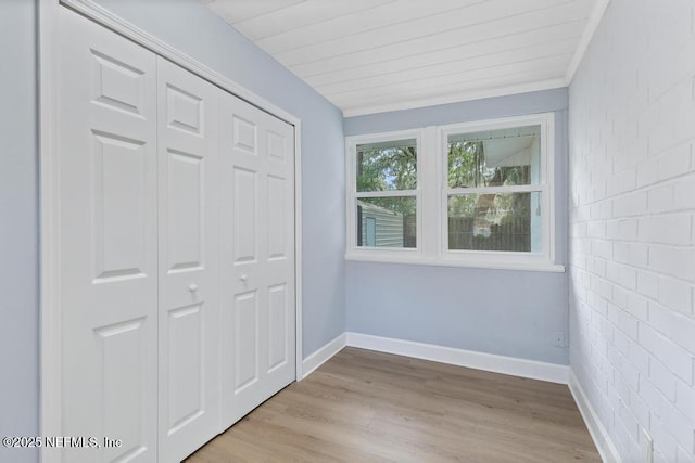 unfurnished bedroom with a closet and light hardwood / wood-style floors