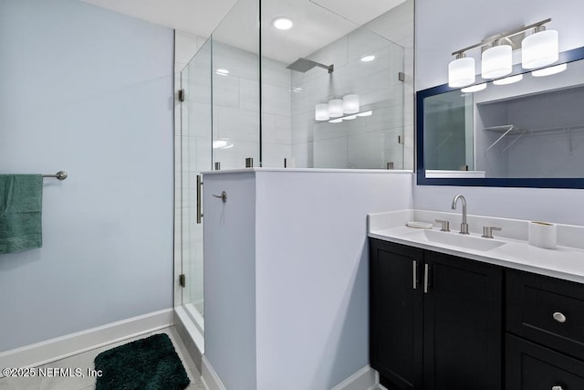 bathroom with tile patterned flooring, an enclosed shower, and vanity