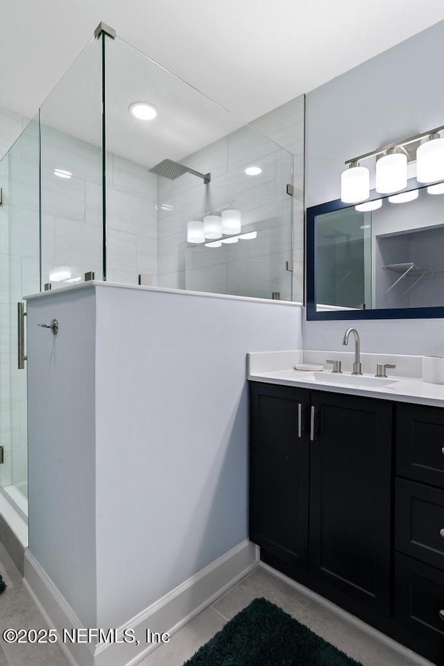 bathroom featuring vanity, an enclosed shower, and tile patterned flooring