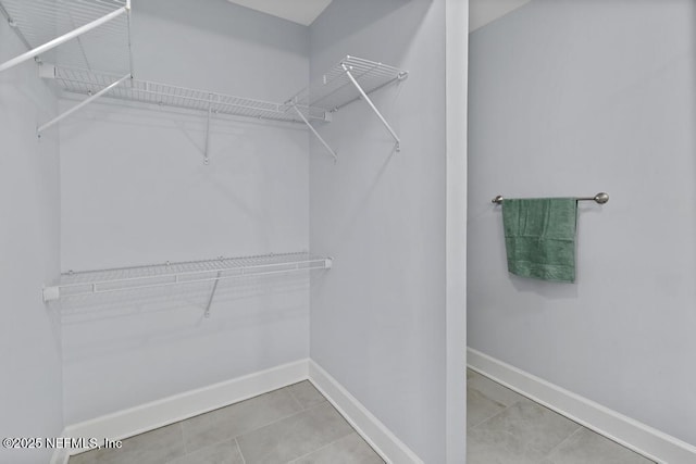 spacious closet featuring tile patterned floors