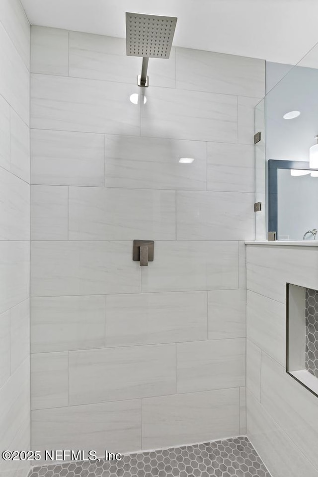 bathroom with a tile shower