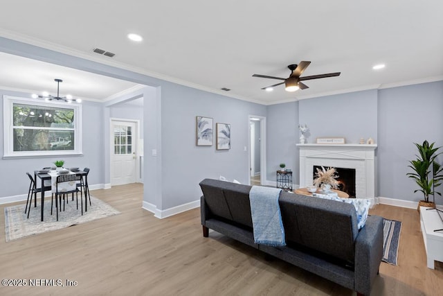 living room featuring crown molding and light hardwood / wood-style flooring