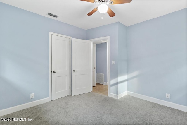 unfurnished bedroom with a closet, ceiling fan, and light carpet