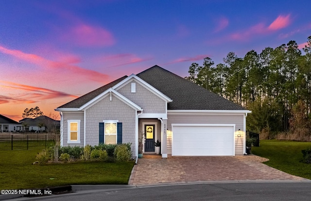 view of front of house with a garage and a lawn