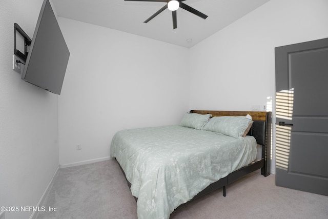 bedroom with lofted ceiling, ceiling fan, and light colored carpet