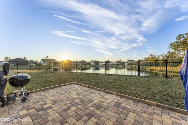 view of patio featuring grilling area and a water view