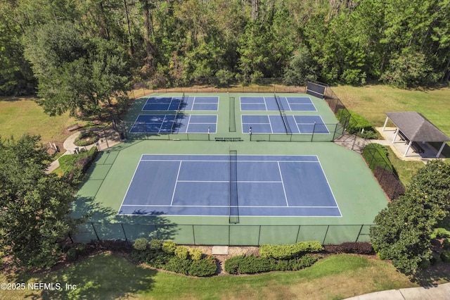 view of sport court featuring a lawn