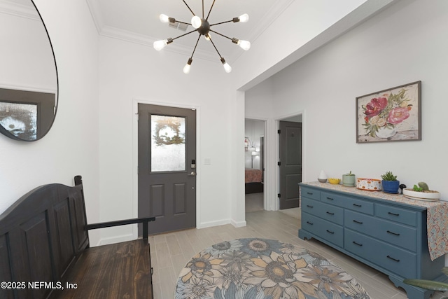 entrance foyer with a notable chandelier and crown molding