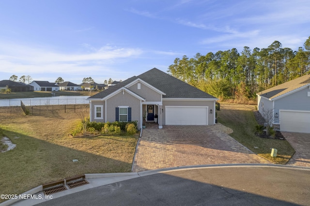 view of front facade featuring a garage and a water view