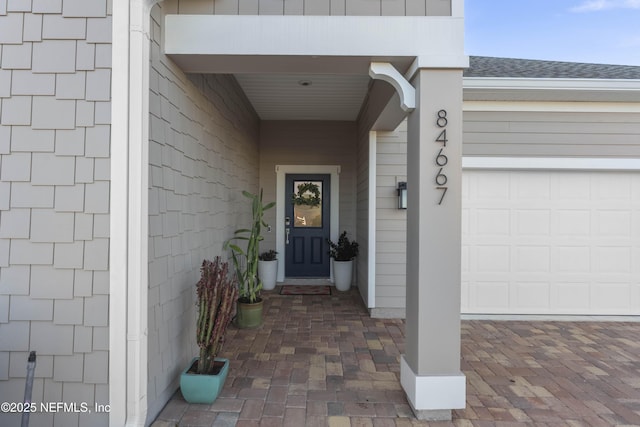 view of exterior entry featuring a garage