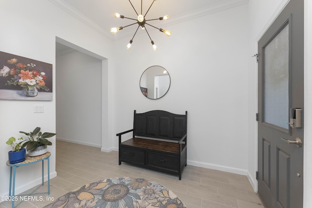 foyer entrance with crown molding and a chandelier