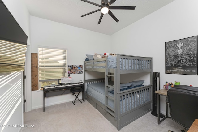 bedroom featuring lofted ceiling, light carpet, and ceiling fan