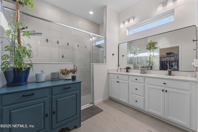 bathroom with vanity and a shower with shower door