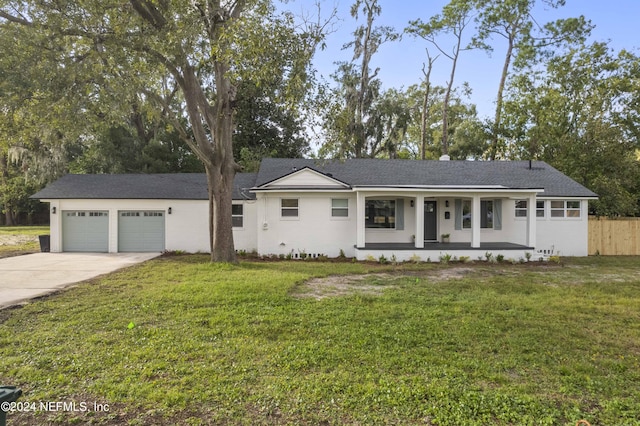 single story home with a porch, a garage, and a front lawn