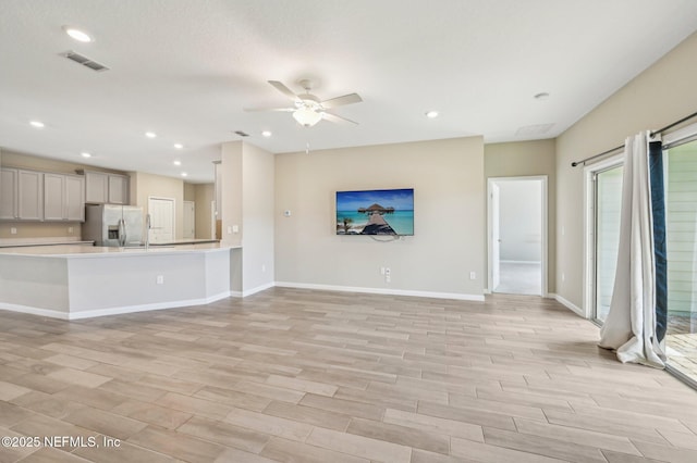 unfurnished living room featuring ceiling fan