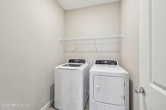 clothes washing area featuring separate washer and dryer