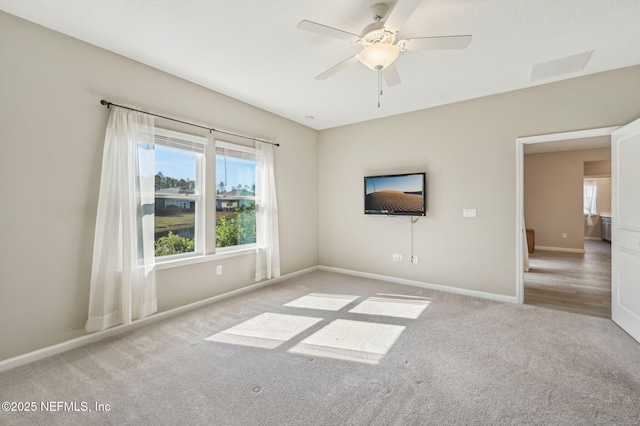 unfurnished room featuring ceiling fan and light colored carpet