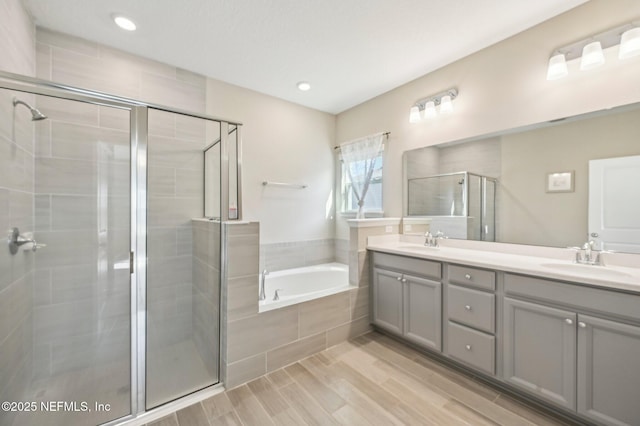 bathroom featuring vanity and separate shower and tub