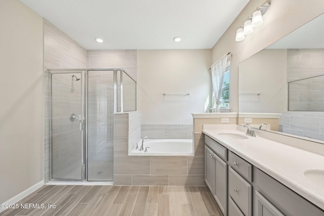 bathroom with plus walk in shower and vanity