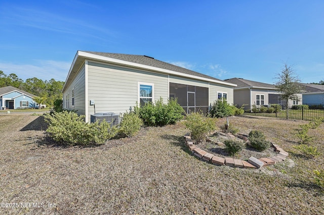 back of property featuring central AC and a sunroom