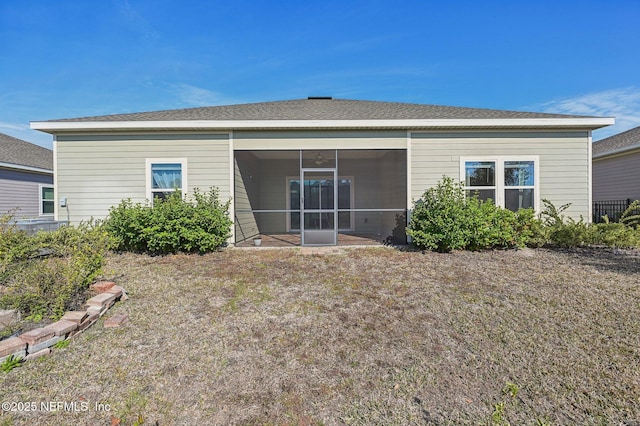 back of house featuring a sunroom