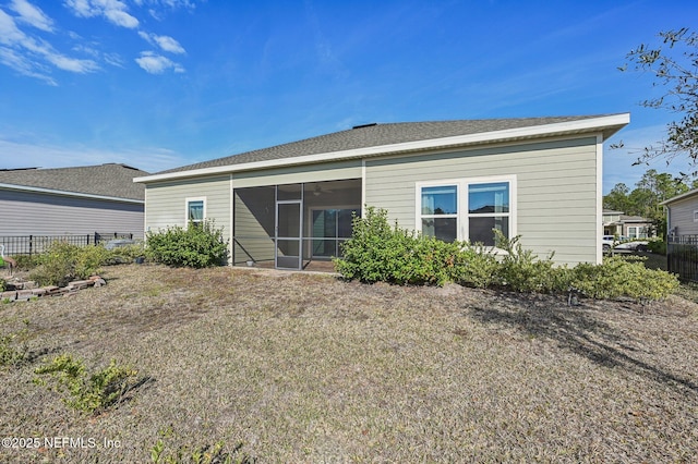 back of property with a sunroom