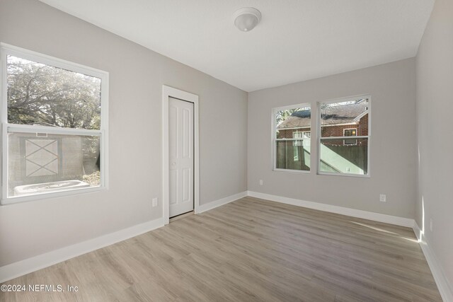 spare room featuring wood-type flooring