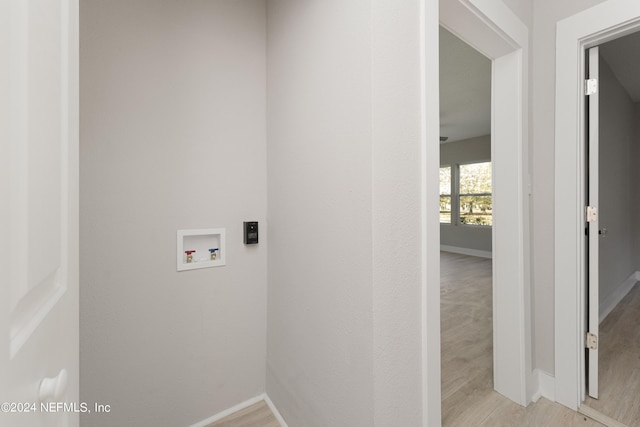 clothes washing area featuring hookup for a washing machine and light hardwood / wood-style floors