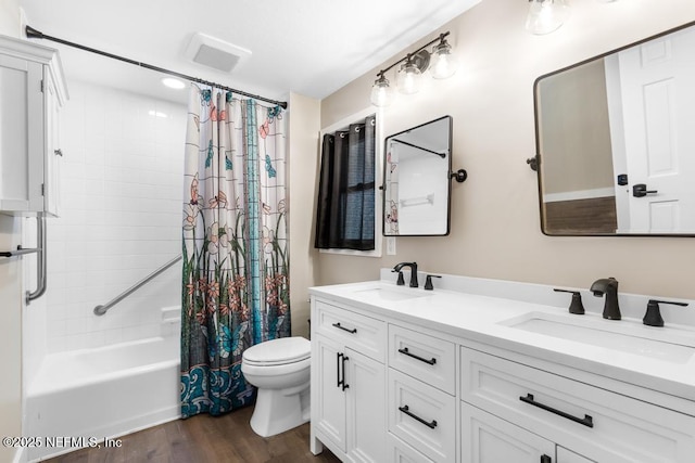 bathroom featuring shower / tub combo, a sink, toilet, and wood finished floors