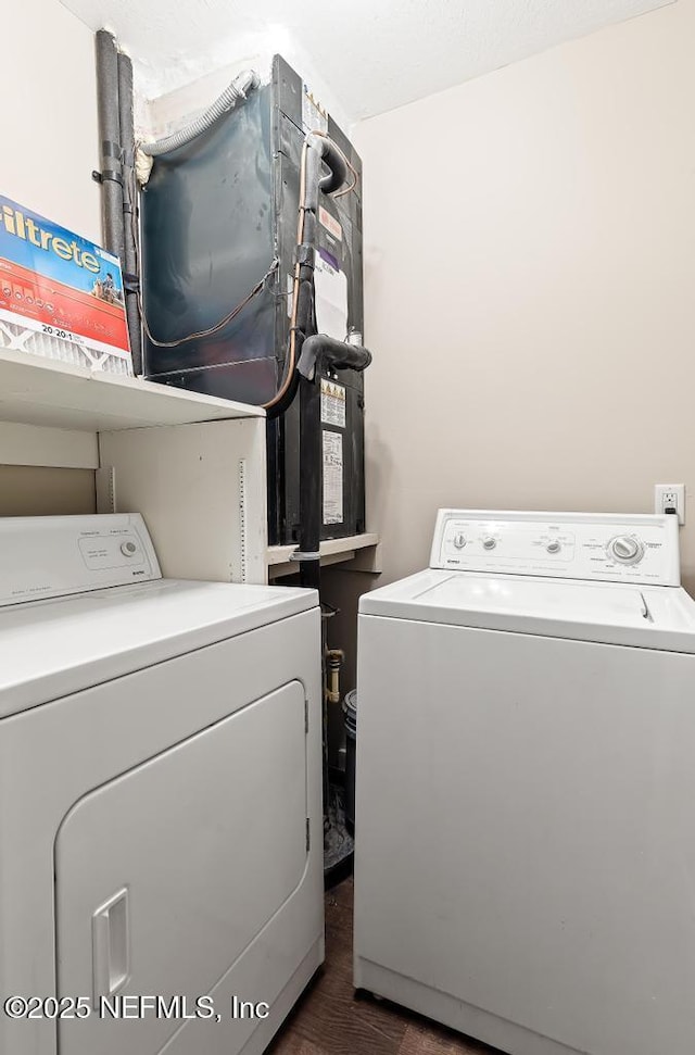 washroom with laundry area, dark wood-style flooring, and washing machine and clothes dryer