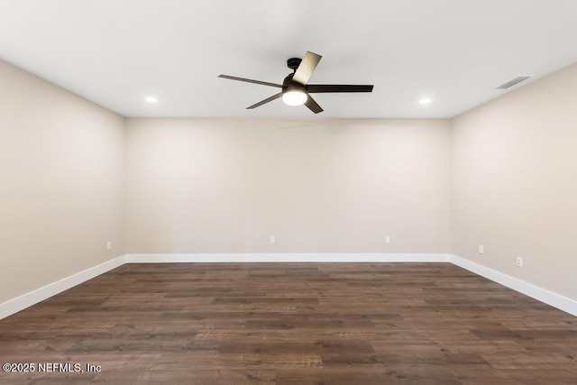 empty room with ceiling fan, dark wood-style flooring, visible vents, and baseboards