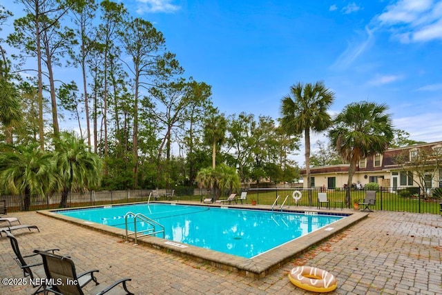 pool with fence and a patio