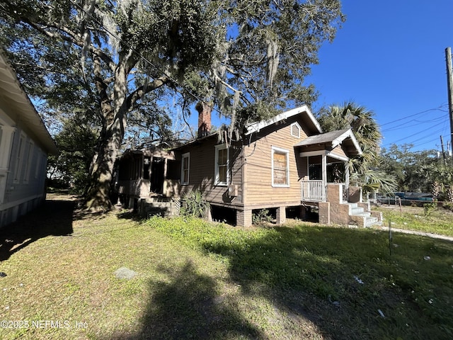 view of property exterior featuring a lawn