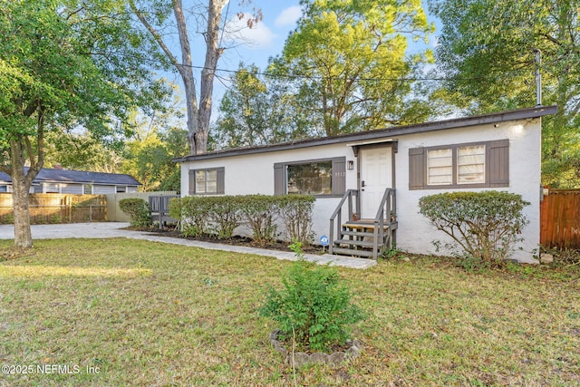 ranch-style home with a front lawn