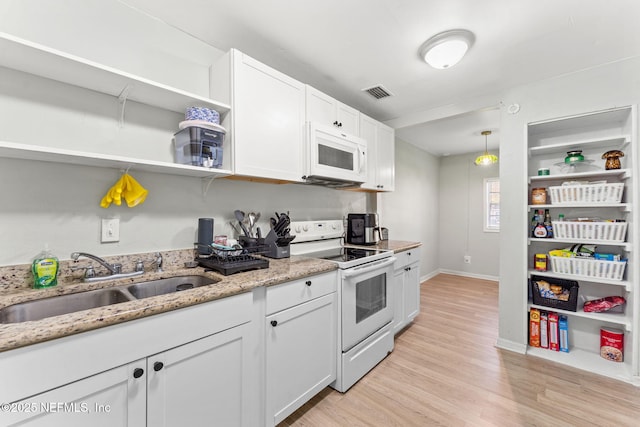 kitchen with white cabinetry, sink, white appliances, and hanging light fixtures