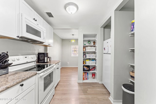 kitchen with hanging light fixtures, light stone counters, light hardwood / wood-style flooring, white appliances, and white cabinets