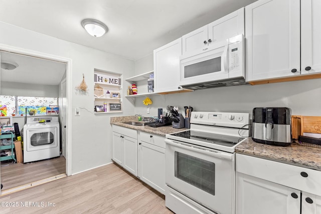 kitchen with washer / clothes dryer, white cabinetry, light hardwood / wood-style flooring, and white appliances