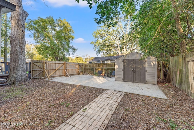 view of yard featuring a patio area and a storage shed