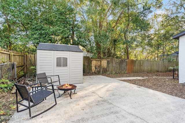 view of patio / terrace featuring a storage unit and an outdoor fire pit