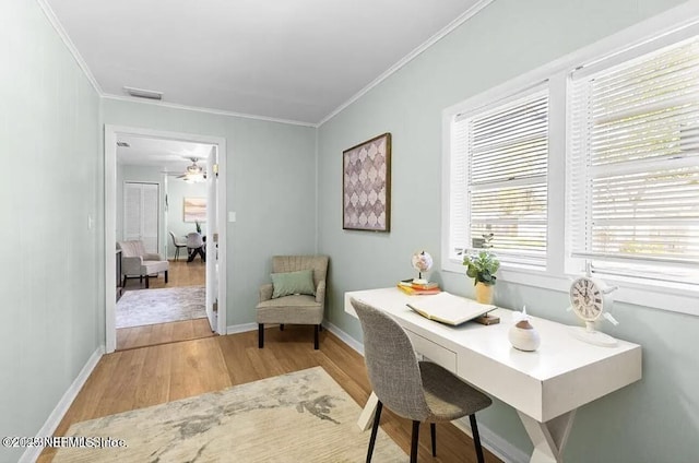 office area featuring crown molding, ceiling fan, and light hardwood / wood-style floors