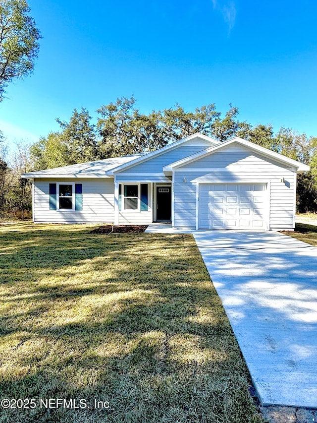 ranch-style house featuring a front lawn and a garage