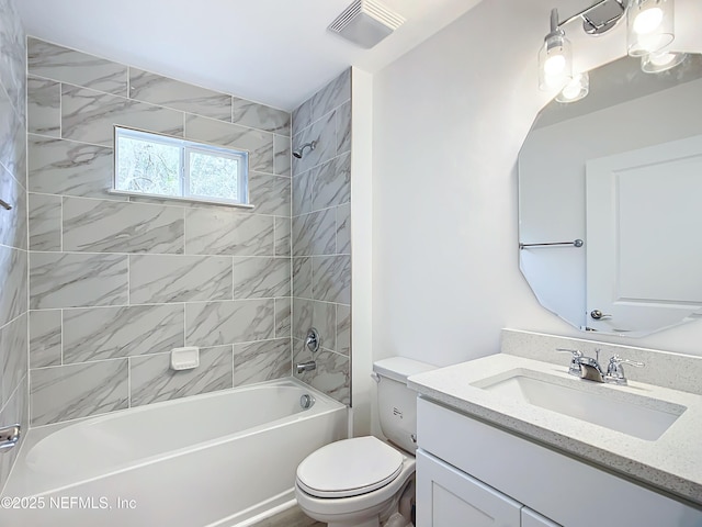 full bathroom featuring tiled shower / bath, vanity, and toilet