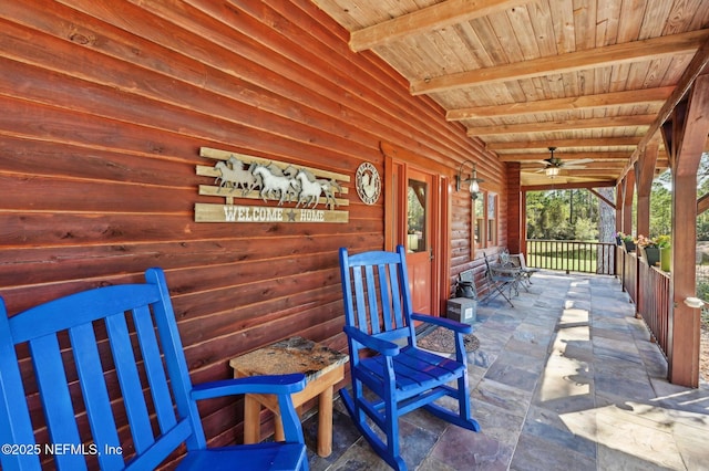 view of patio with ceiling fan and a porch