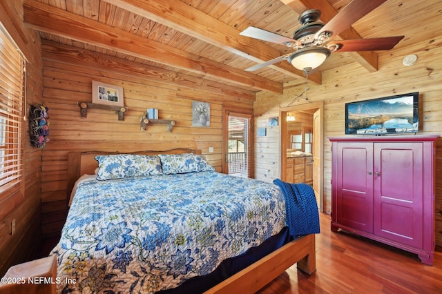 bedroom with wood ceiling, beam ceiling, dark wood-type flooring, and wood walls